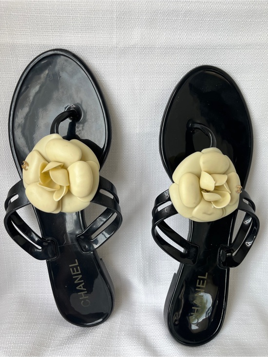 CHANEL Shoes - CHANEL Black Jelly Sandals with Cream Camellia Accent